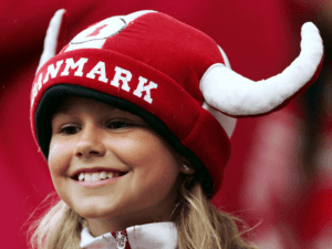 a close up of a girl wearing a red hat