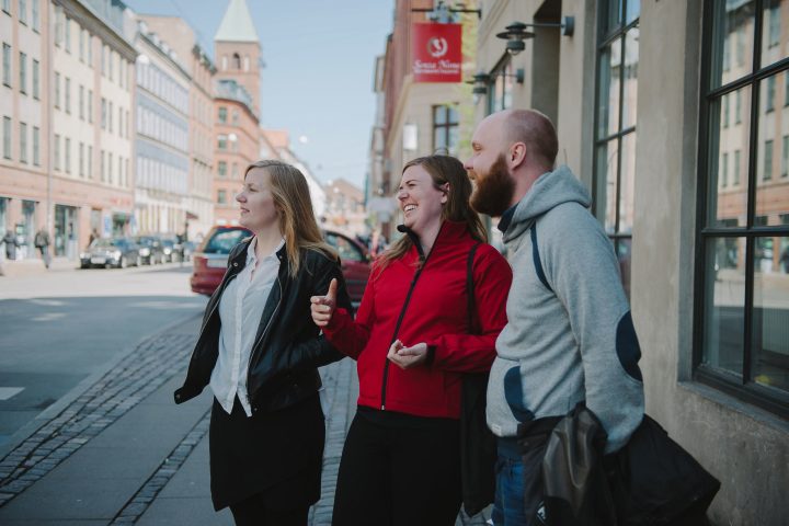 a man and a woman walking down the street talking on a cell phone